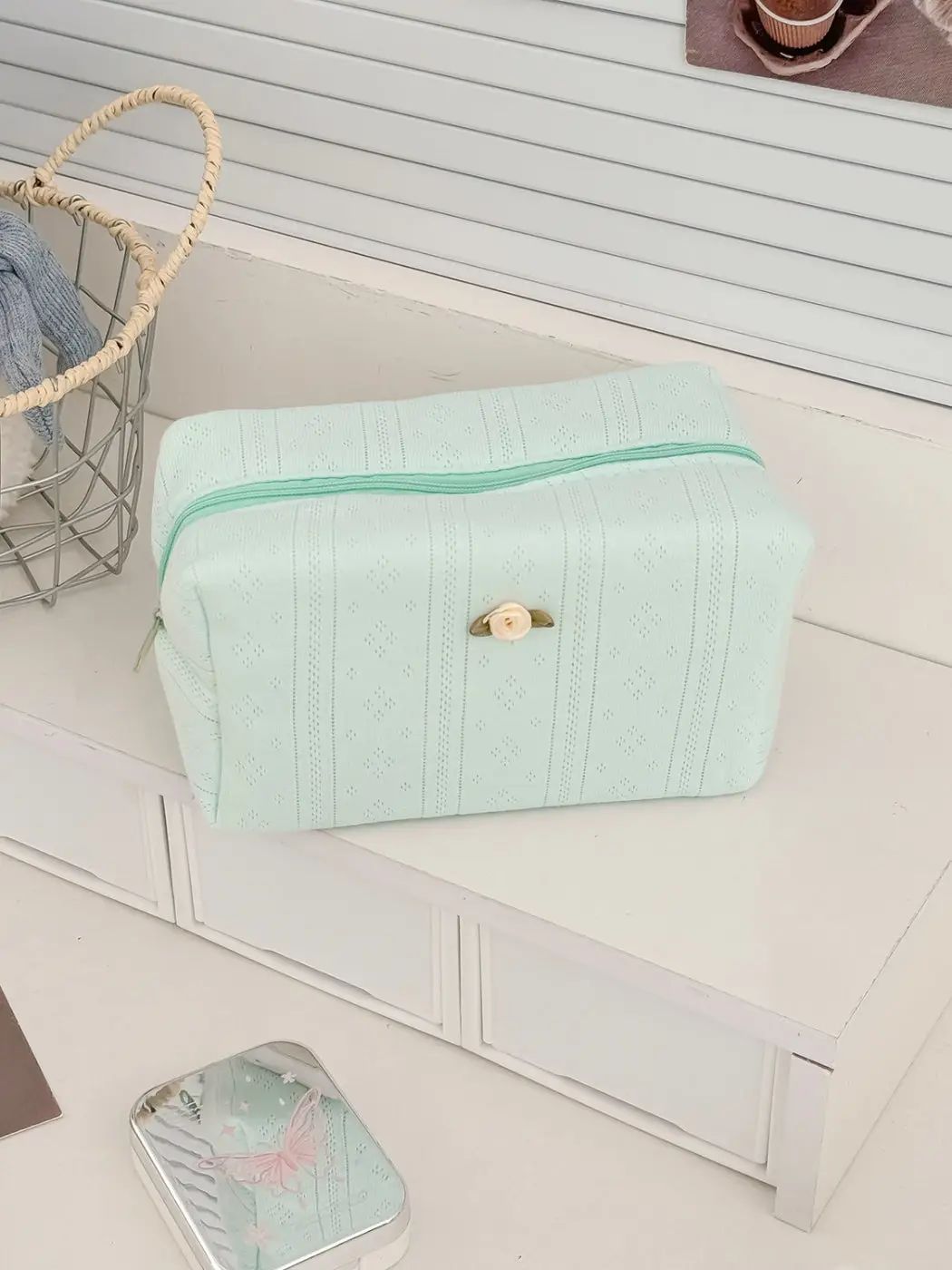 Textured cosmetic pouch with rose detail, product photo