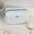 Textured cosmetic pouch with rose detail, alternate view