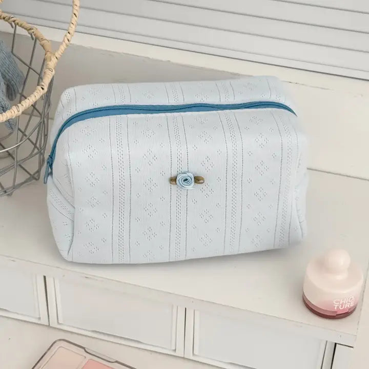 Textured cosmetic pouch with rose detail, alternate view