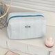 Textured cosmetic pouch with rose detail, alternate view