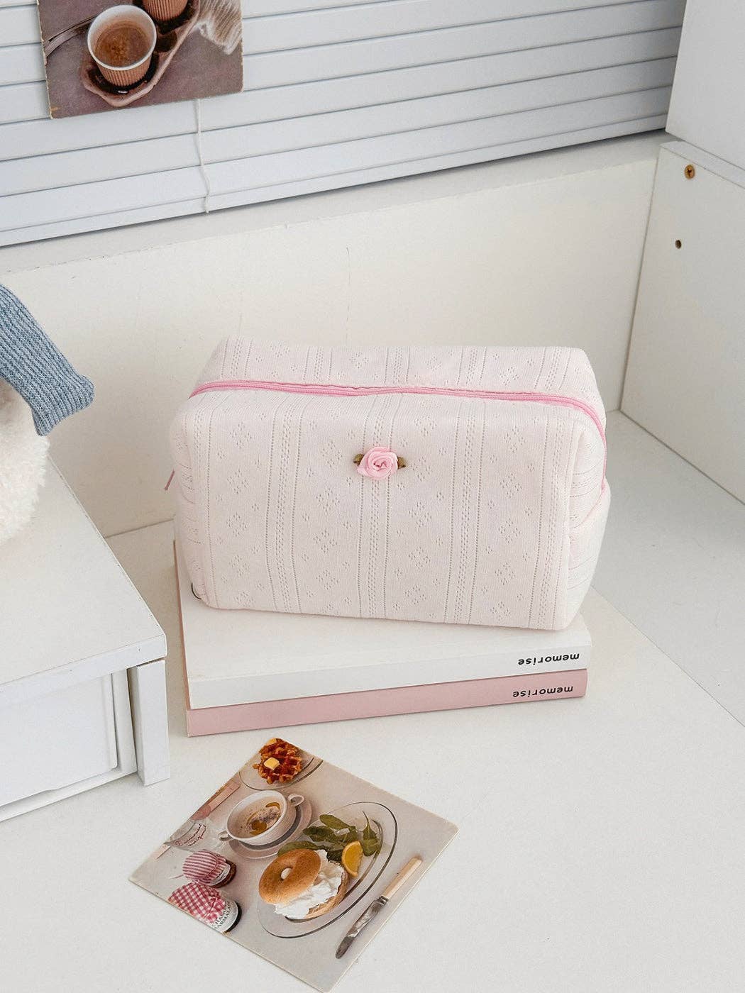 Pink textured cosmetic pouch with rose detail