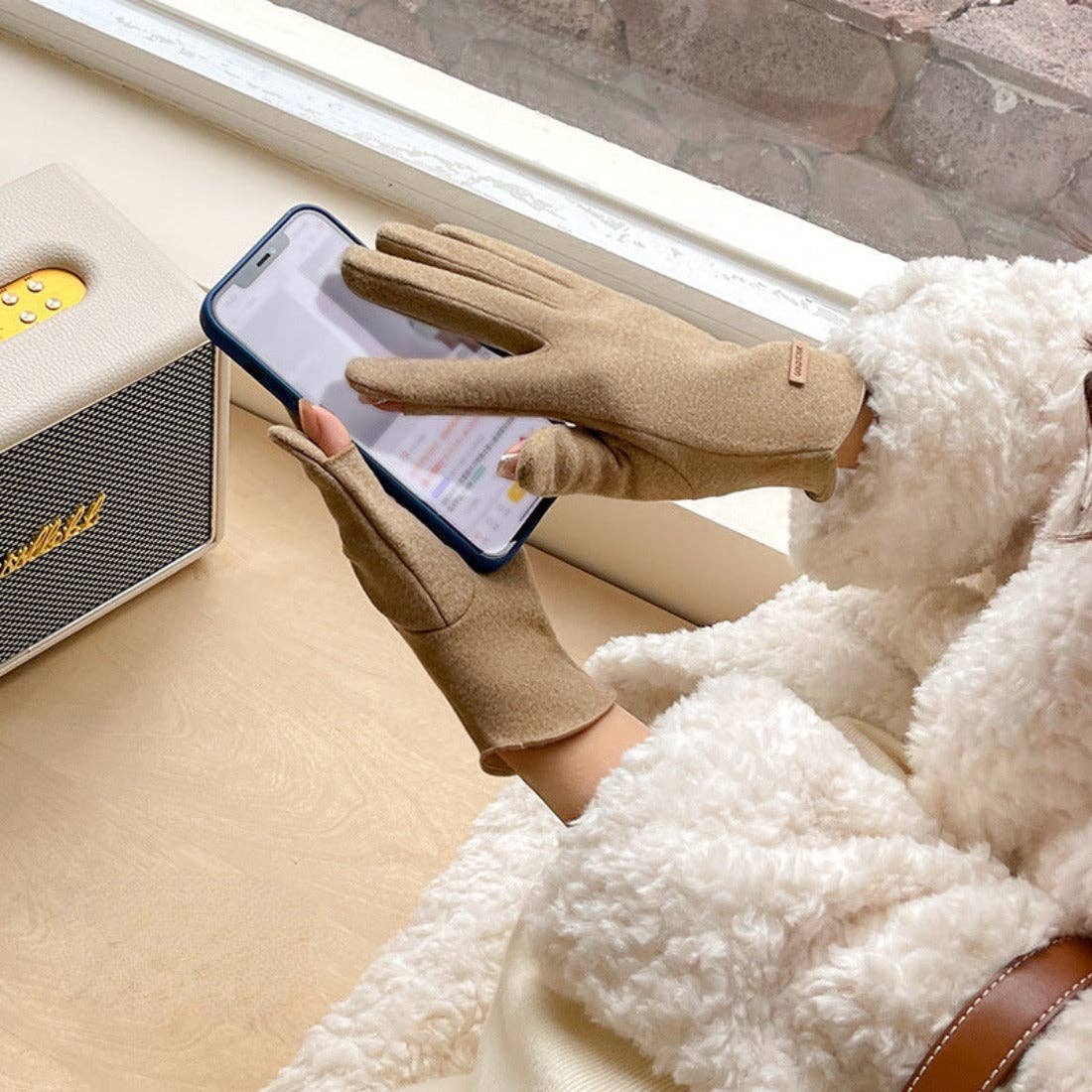 Woman using a phone while wearing the touchscreen gloves