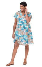 Woman wearing a patterned dress on a white background