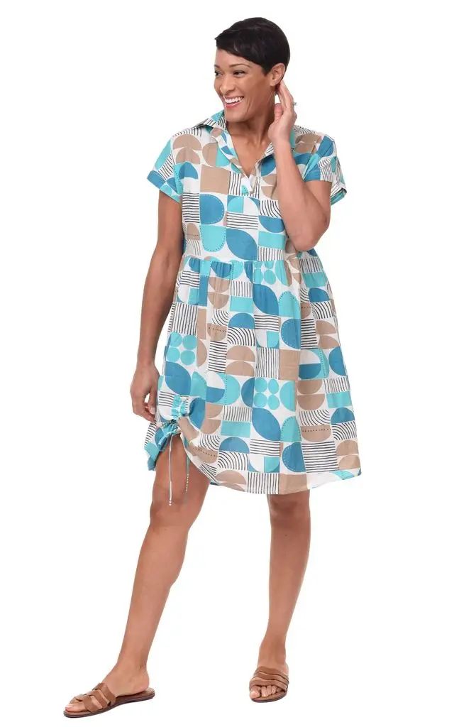 Woman wearing a patterned dress on a white background