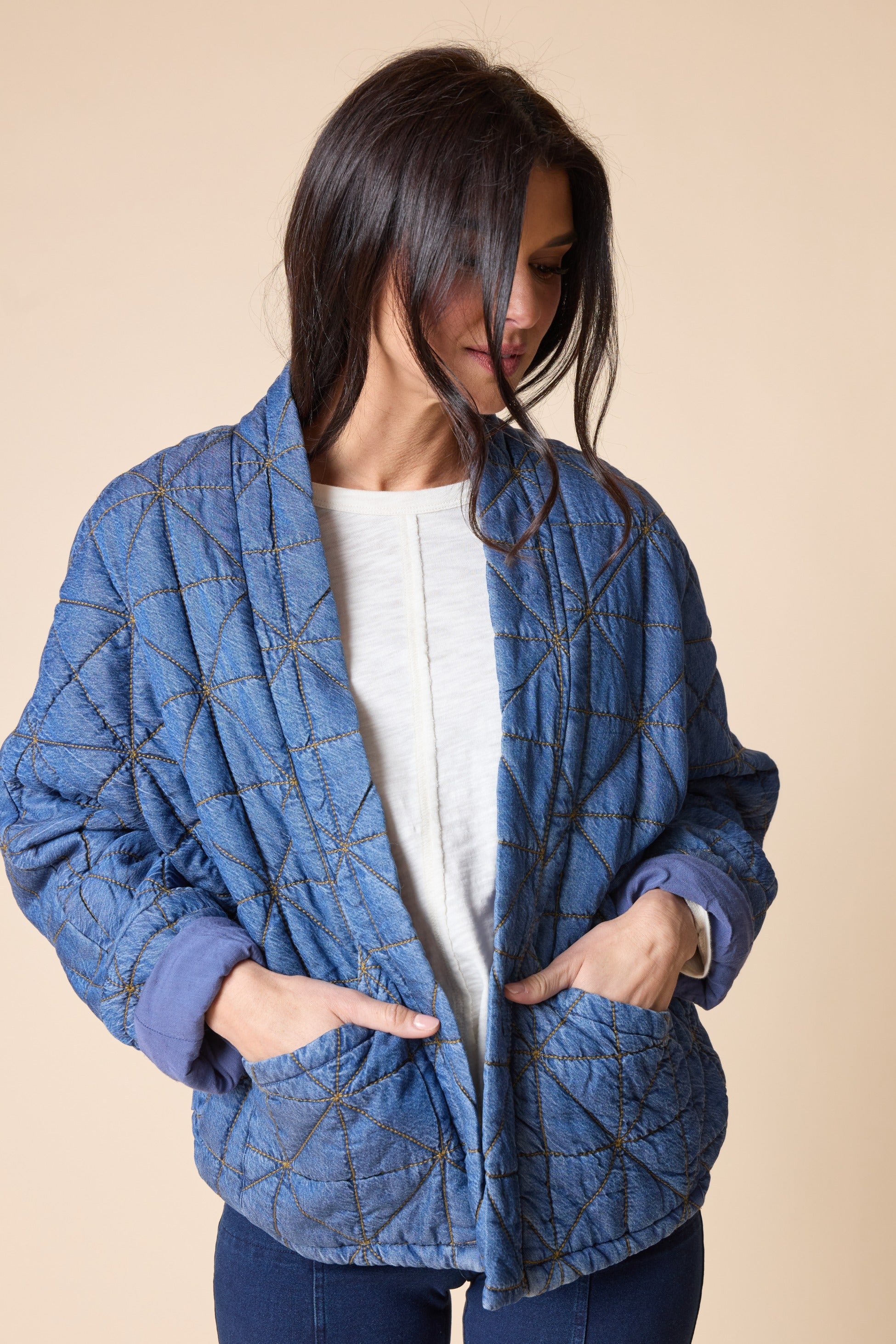 Habitat Diamond Quilt Kimono Jacket in medium denim with hands in patch pockets, three-quarter view