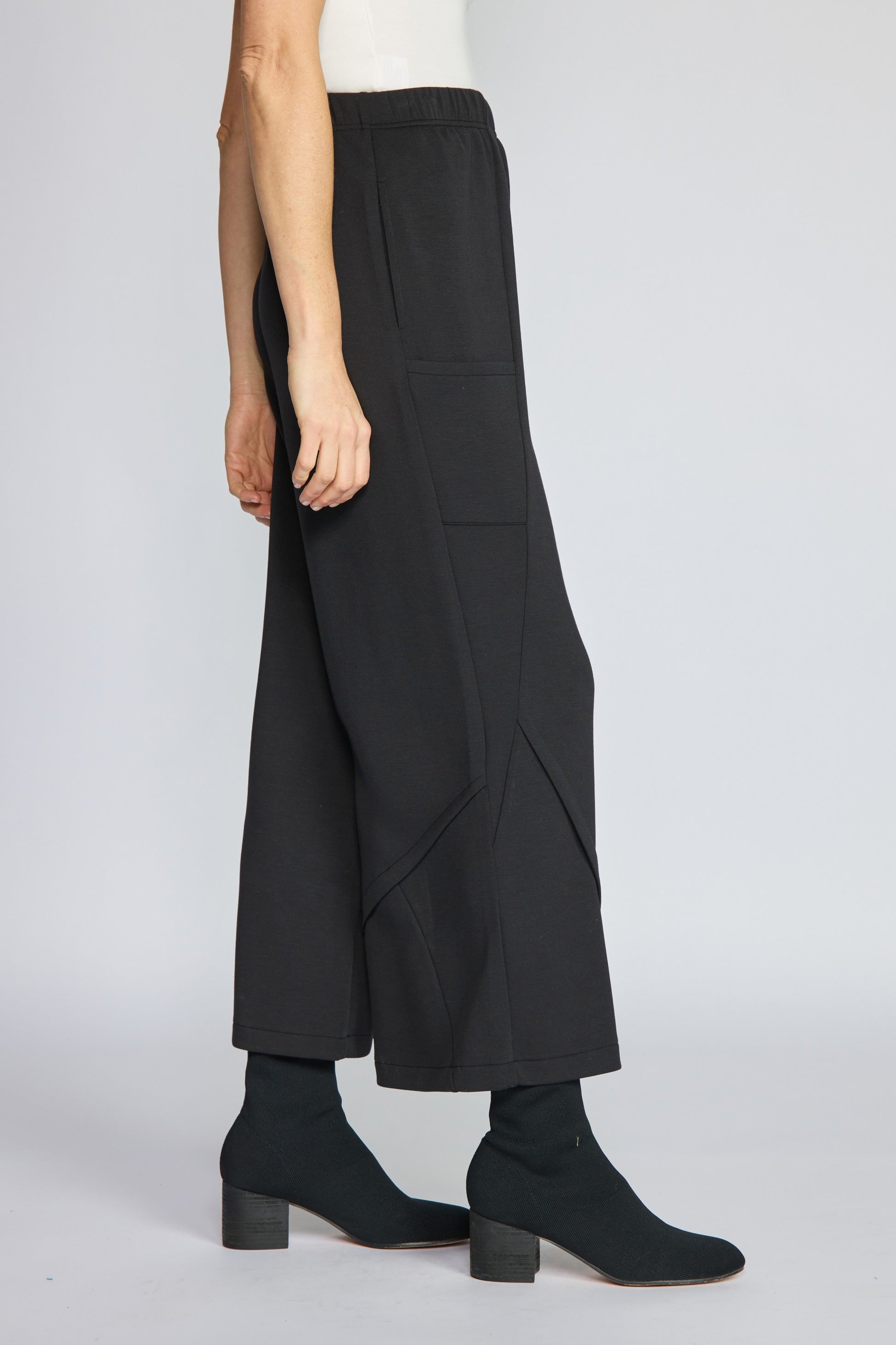Side view of the Habitat Featherlux Knit Crossroads Pant in black showing the seamed wide leg