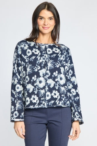 Woman wearing the Habitat Focus Floral Rolled Edge Pullover in navy with a white floral print, styled with dark pants