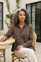 Habitat Rayon Crepe Garden Flounce Shirt in olive floral, seated on a patio