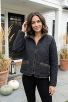Habitat Reversible Print Quilt Puffer Coat in black with stand collar and print-trimmed patch pockets, styled outdoors for fall