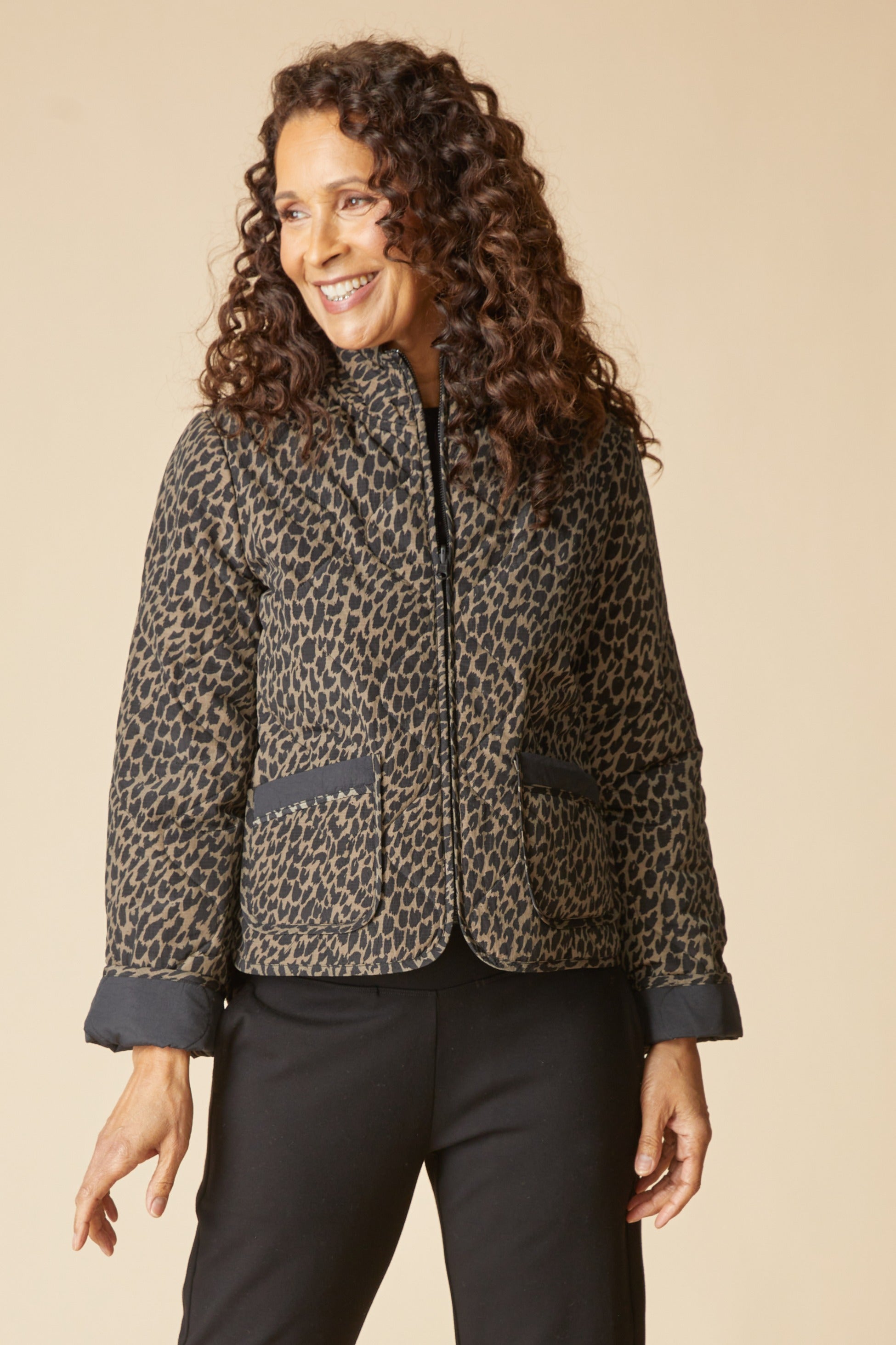 Habitat Reversible Print Quilt Puffer Coat zipped with the animal print side out and black cuffs turned back