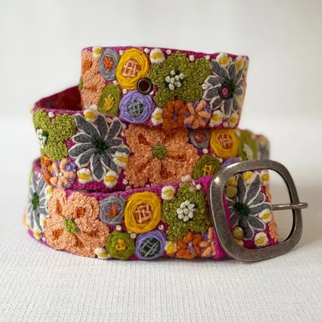 Colorful embroidered belt with floral patterns on a white background