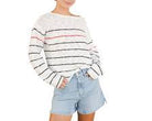 Person wearing a striped sweater and denim shorts on a plain background