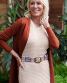 Model wearing the Jenny Krauss Folklorica Floral Embroidered Wool Belt in cream at the waist
