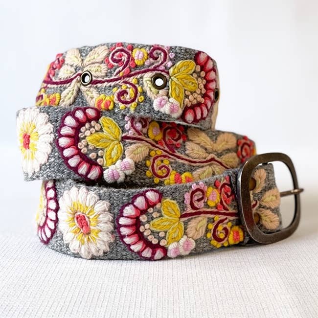 Jenny Krauss Heather Gray Floral Embroidered Wool Belt in heather gray, coiled to show the hand embroidery