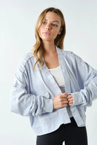 woman wearing black pants and light blue cardigan