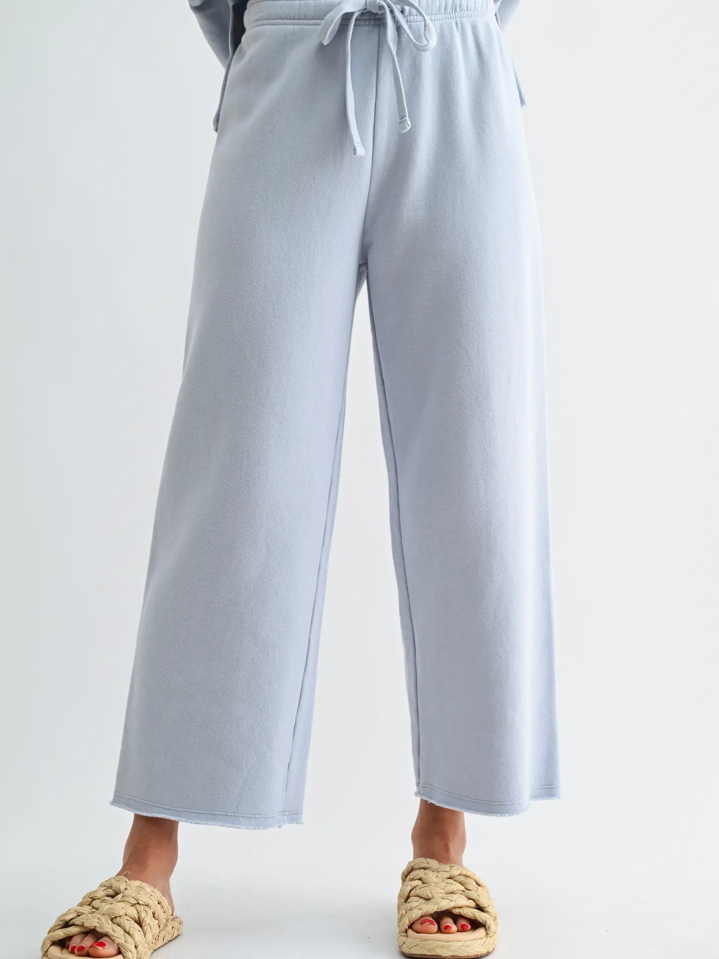 Light blue wide-leg pants worn by a person on a white background