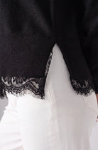 Close-up of the lace trim detail on the black Liverpool V-neck sweater