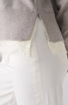 Close-up of the lace trim on the soft grey heather Liverpool V-neck sweater
