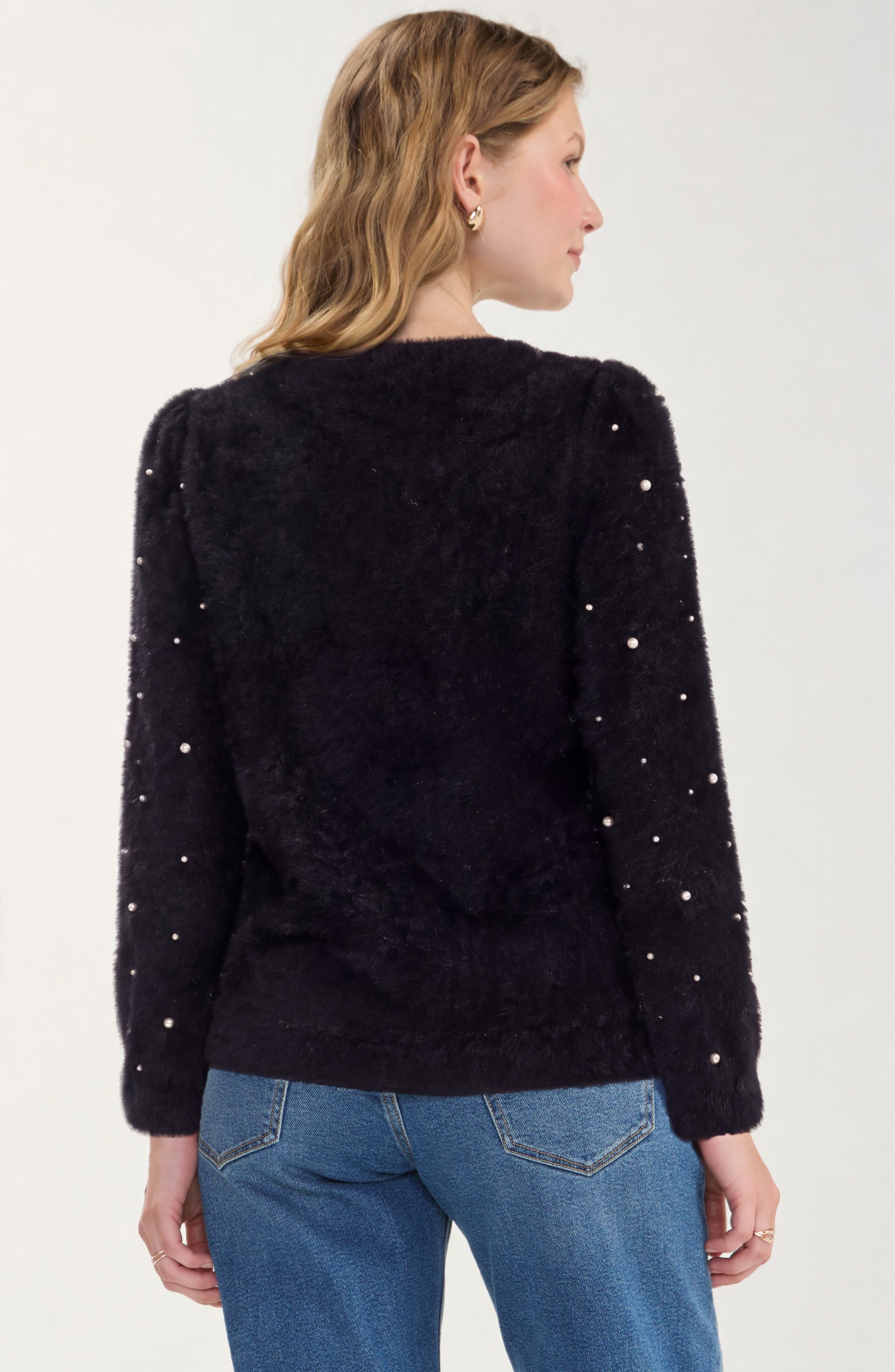 Detail of the puff sleeve and pearls on the black Liverpool sweater