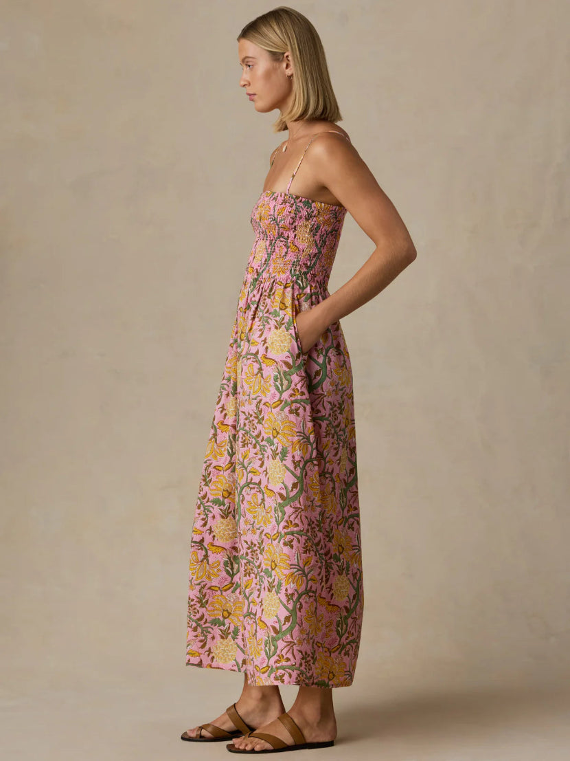 Woman wearing a floral dress against a beige background