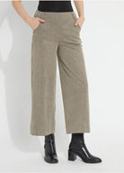 Model wearing the Lysse Clarke Wide Leg pant in olive-taupe Everwood Sheen Line stripe, cropped length, with black ankle boots