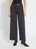 Model wearing the Lysse Denver Hi Waist Wide Leg Printed Ponte pant in charcoal Midnight Manor plaid with black ankle boots