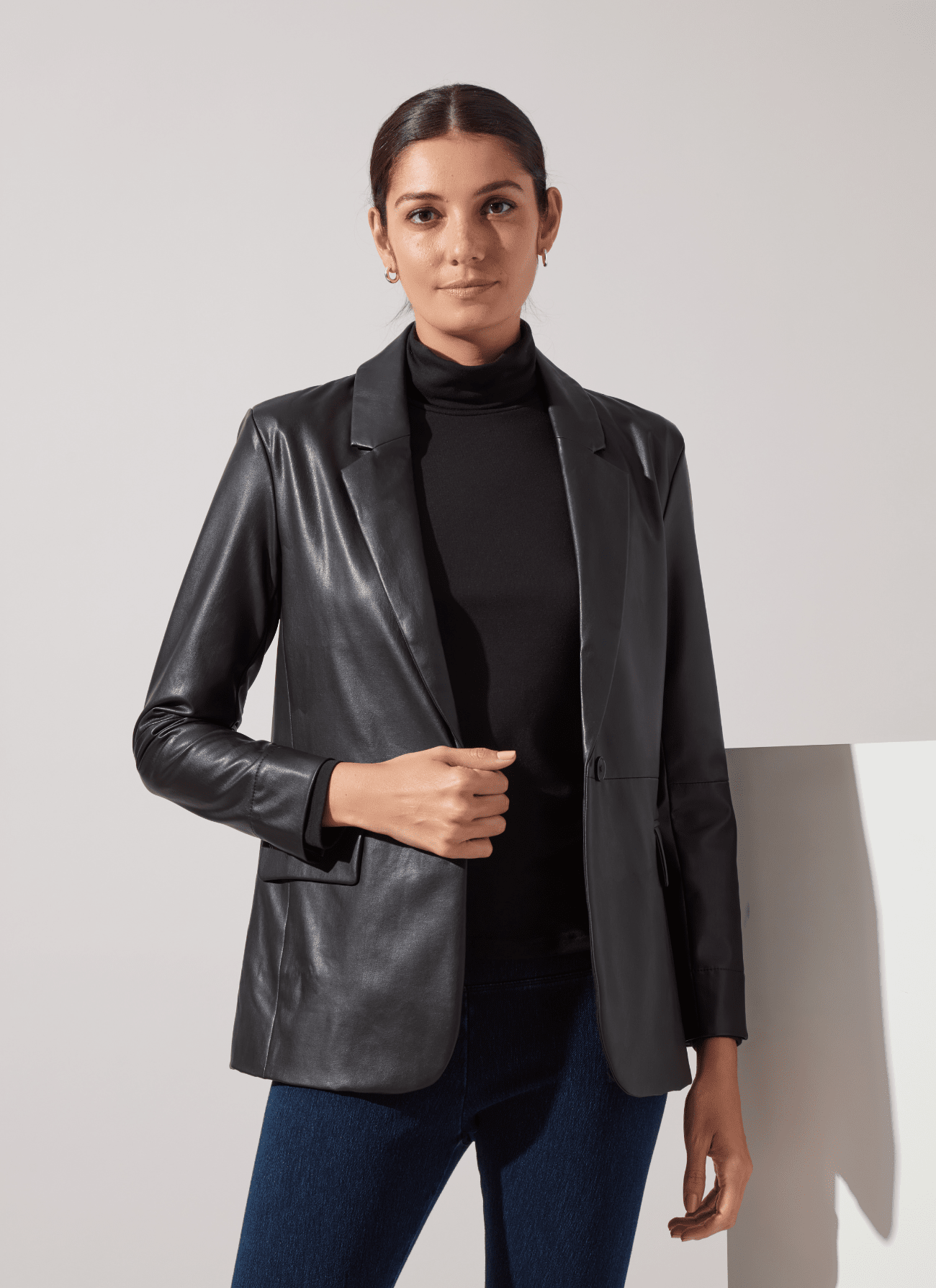 Lysse Essential Longsleeve Turtleneck in Black, styled under a black leather blazer with jeans