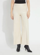 Model wearing the Lysse Hi Waist Vegan Leather Wide Leg pant in travertine cream with black pointed ankle boots