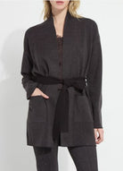 Model wearing the Lysse Laila Double Faced Belted Cardigan in black and grey melange with a black tie belt and patch pockets