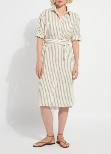 Woman wearing a striped dress on a plain background