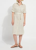 Woman wearing a striped dress on a plain background