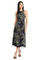 Model wearing the Maggy London Constance Midi Sheath Dress in Black/Champagne, a sleeveless mock-neck midi with champagne botanical embroidery on black mesh and a sheer tulle hem