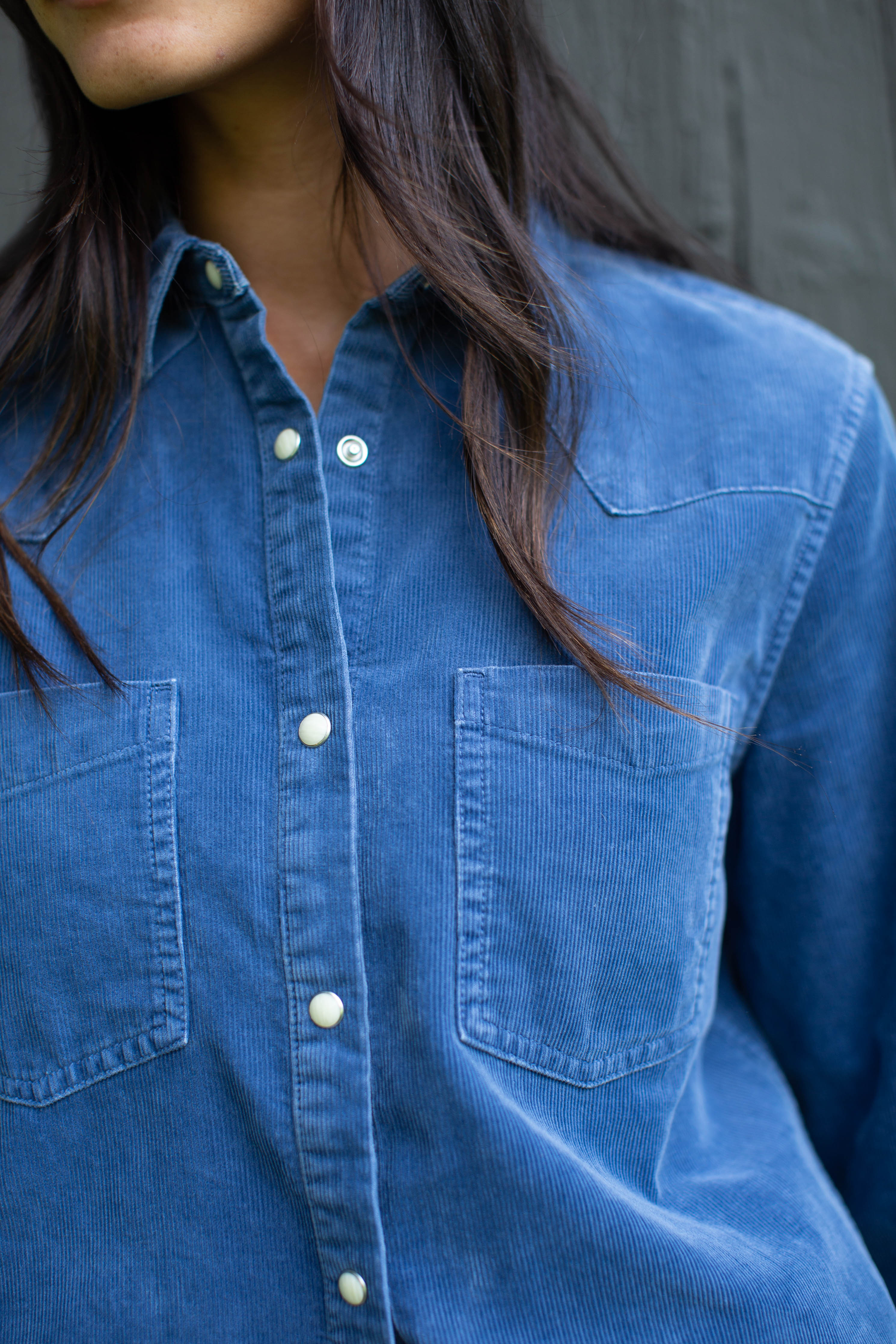 Close-up of the Marea Corduroy Western Shirt in Indigo showing the yoke, chest pockets and pearl snaps