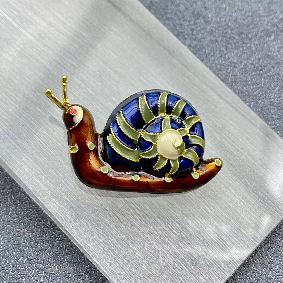 Mio Queena Enamel Snail Brooch, front view