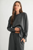 woman wearing ash grey matching top and pant with white background