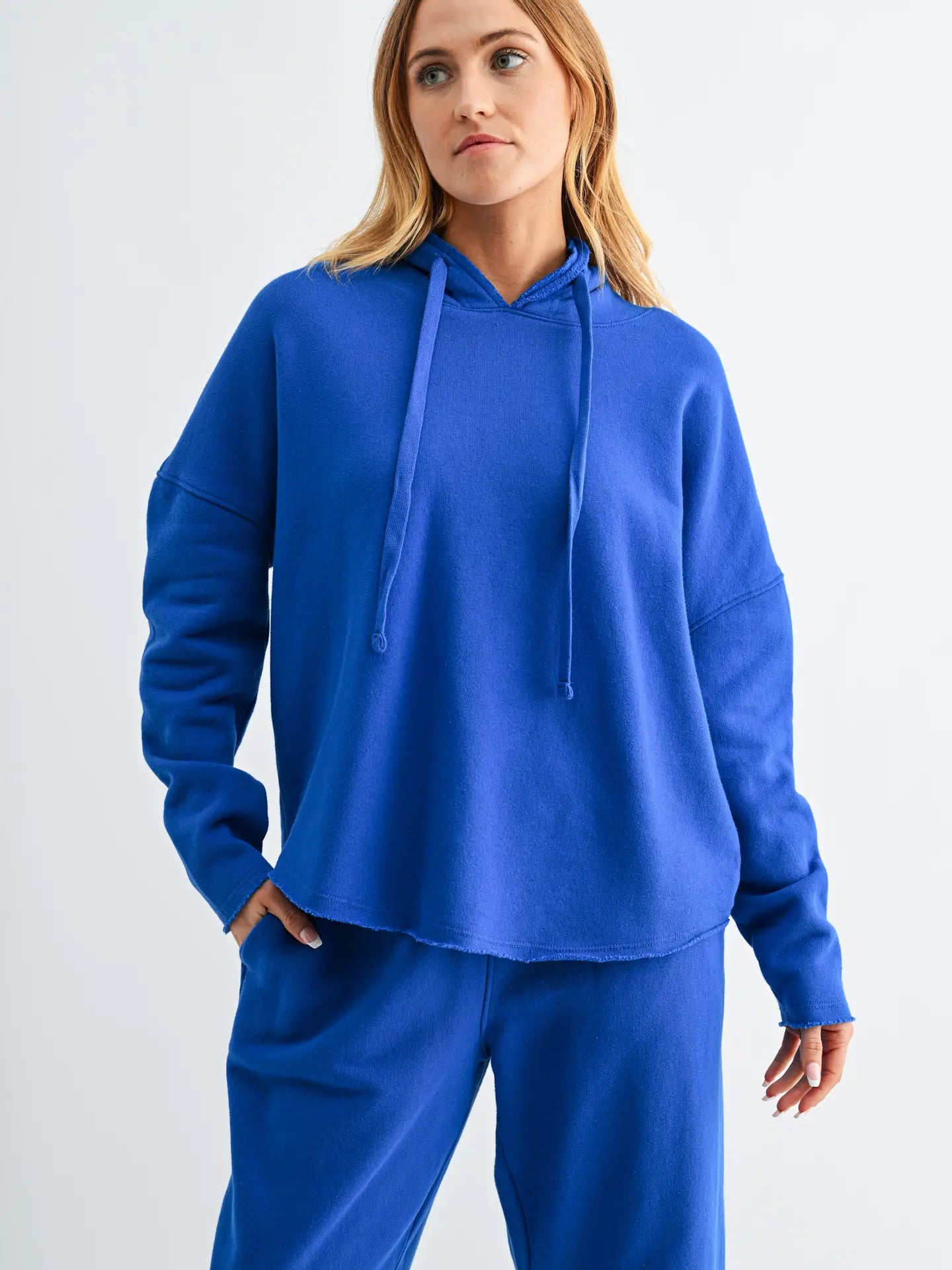 woman wearing bright blue hoodie and matching pants