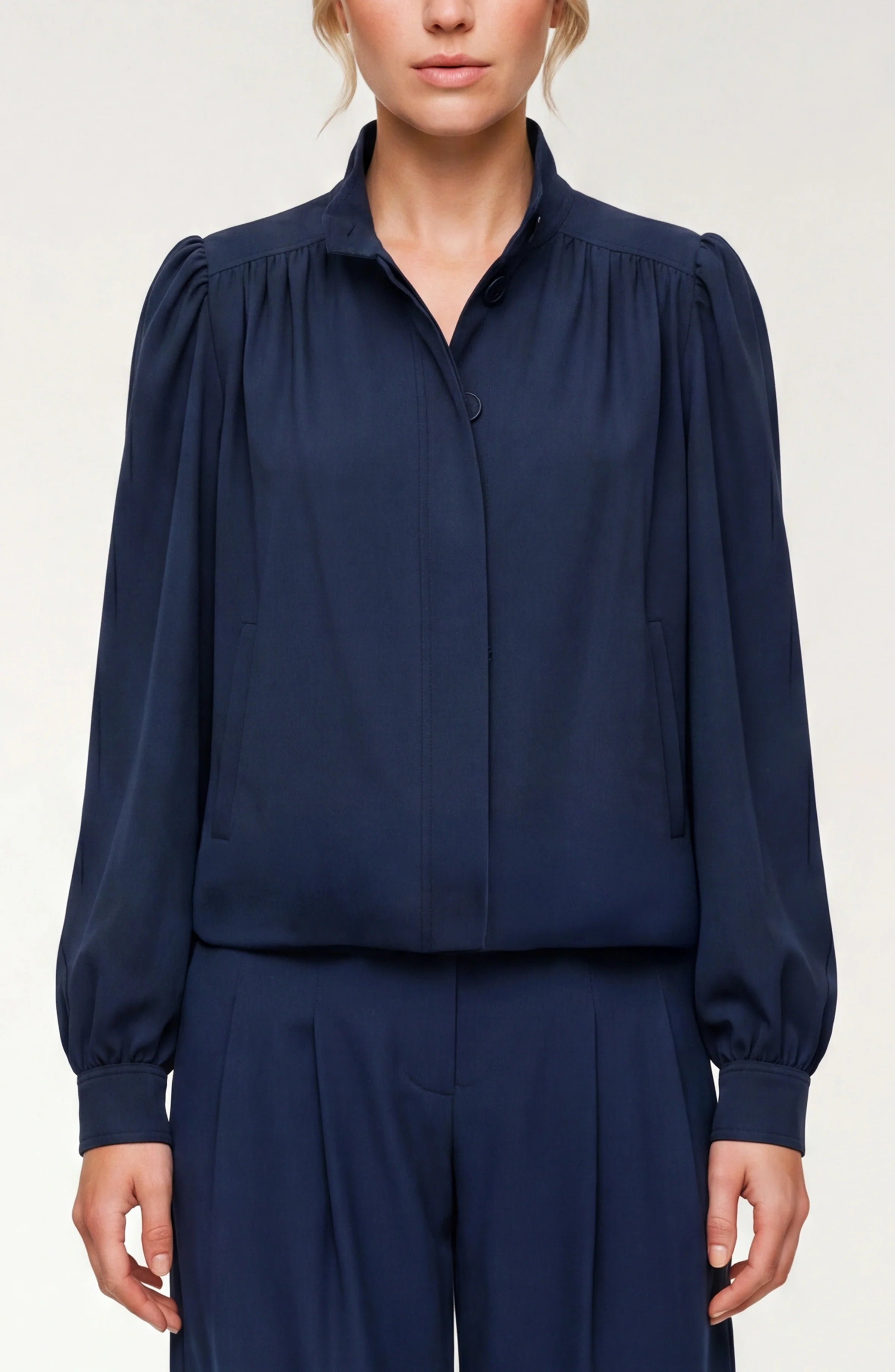 Navy blue blouse with long sleeves on a white background