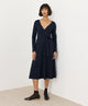 PACT Fit and Flare Wrap Dress in solid navy, long-sleeve V-neck wrap midi with self-tie waist, front view