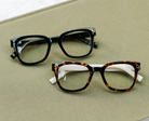 Peepers Aubrey blue light reading glasses in black, styled flat lay