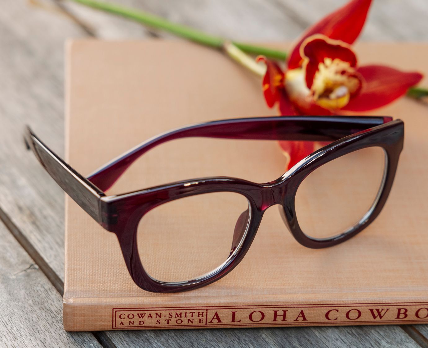 Peepers Center Stage reading glasses in Dark Cherry, styled flat lay