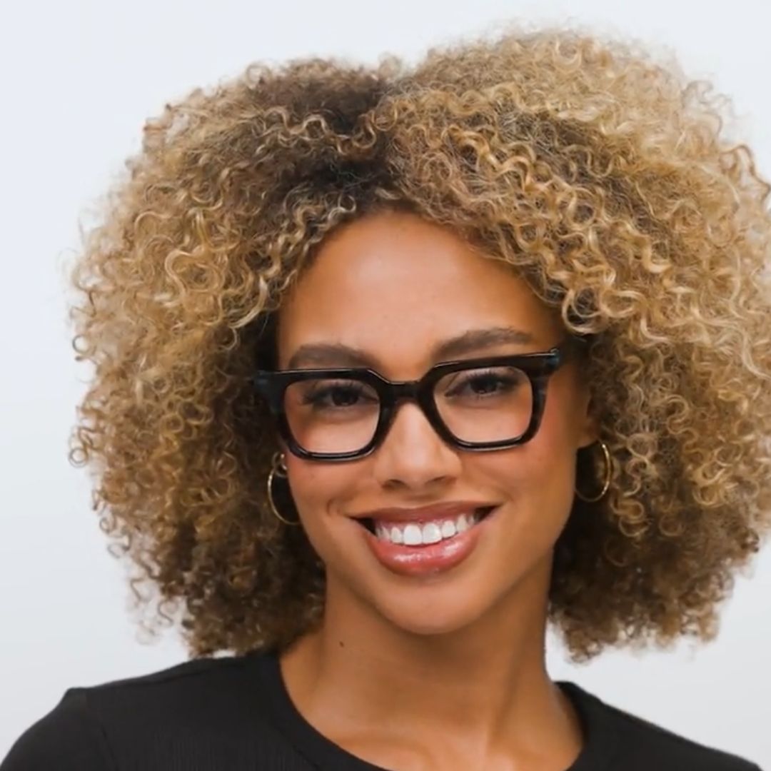 Woman wearing Peepers Page blue light reading glasses in Teal Horn