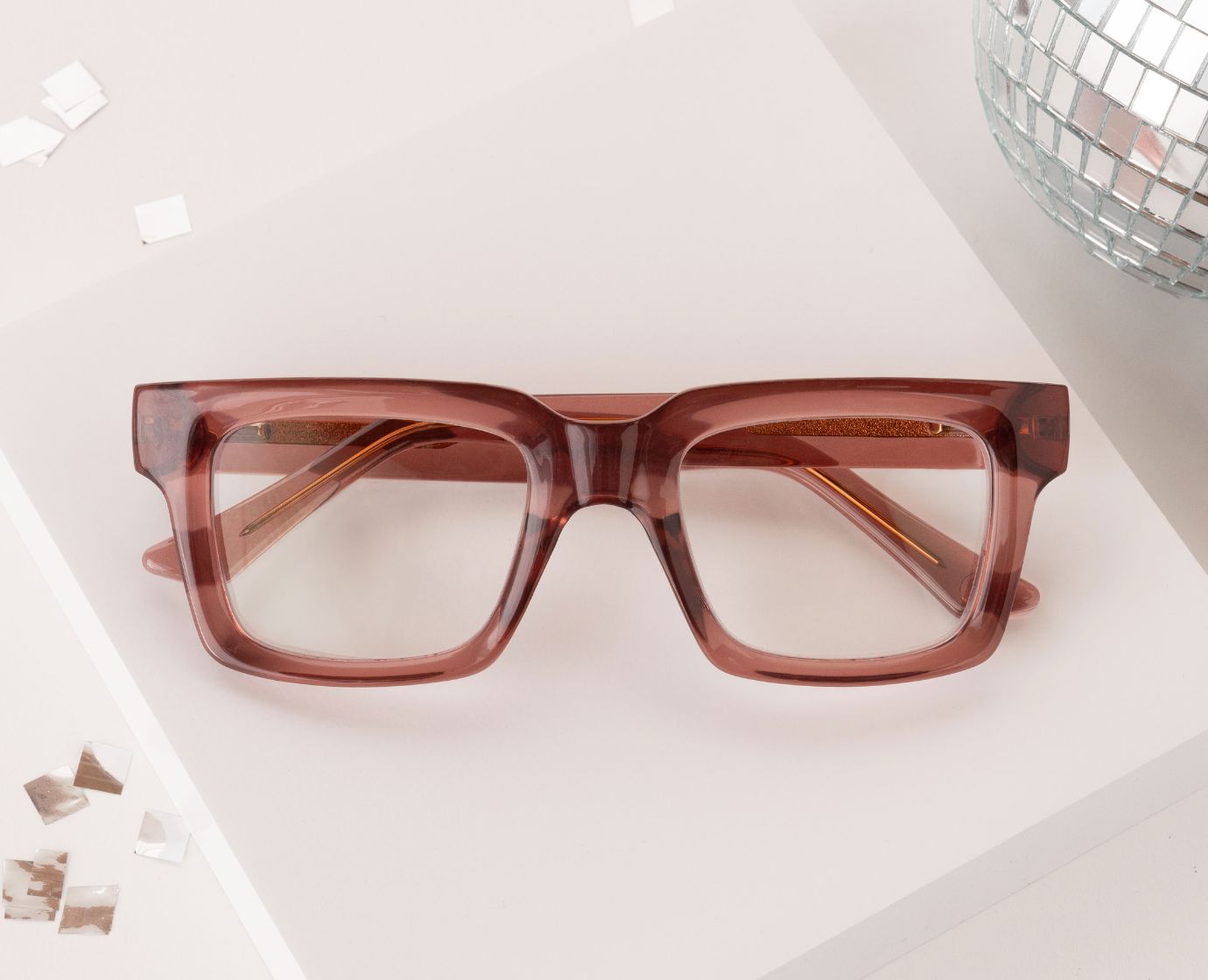 Peepers Spotlight reading glasses in rose, styled flat lay