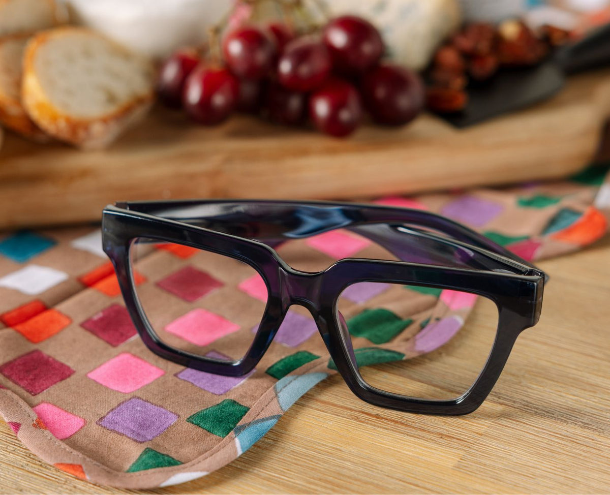 Peepers Take A Bow reading glasses in navy, styled flat lay