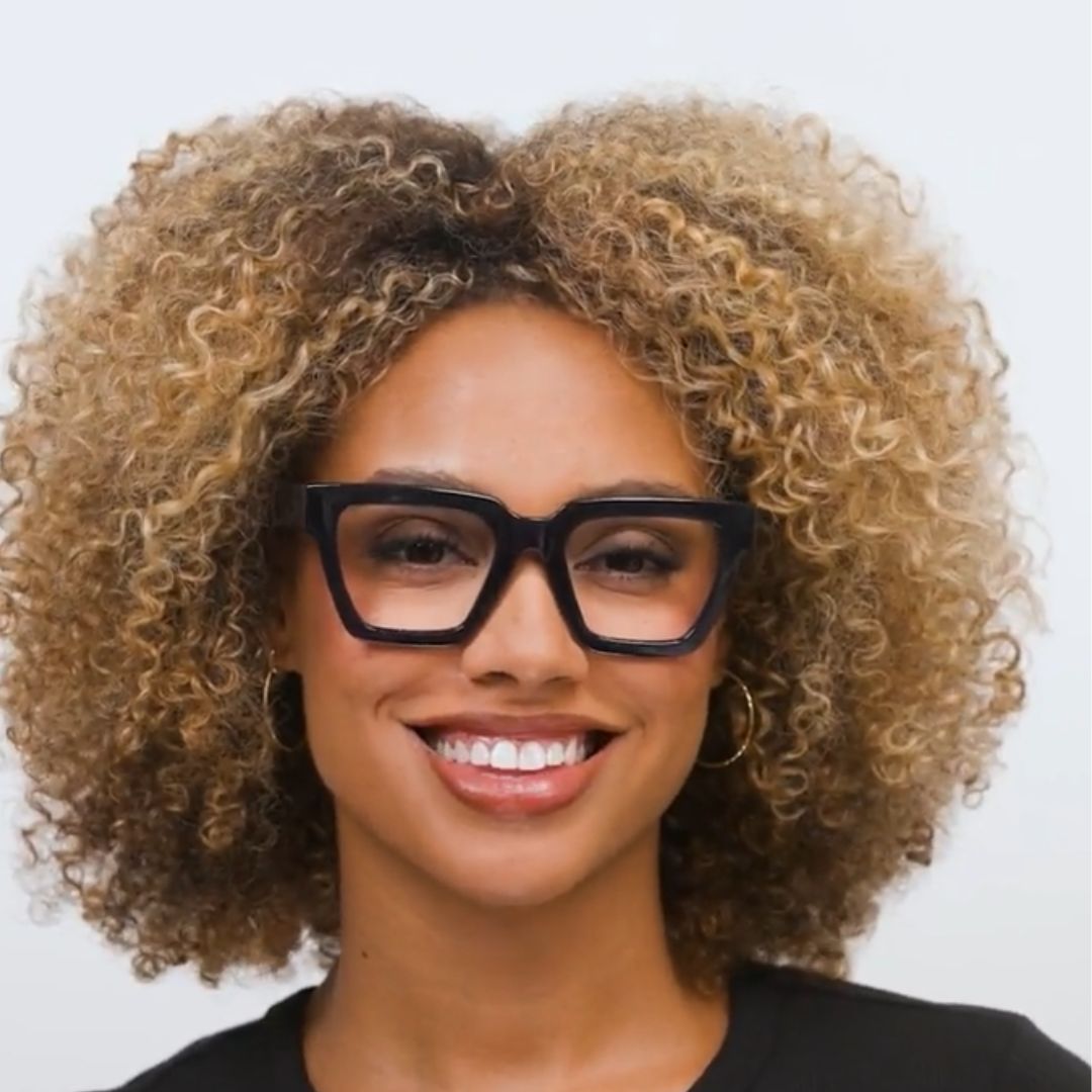 Woman wearing Peepers Take A Bow blue light reading glasses in navy