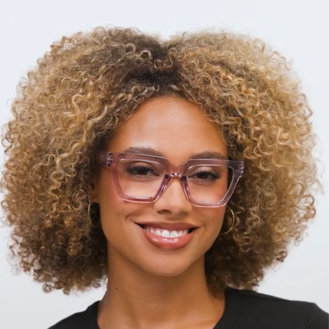 Woman wearing Peepers Take A Bow blue light reading glasses in purple