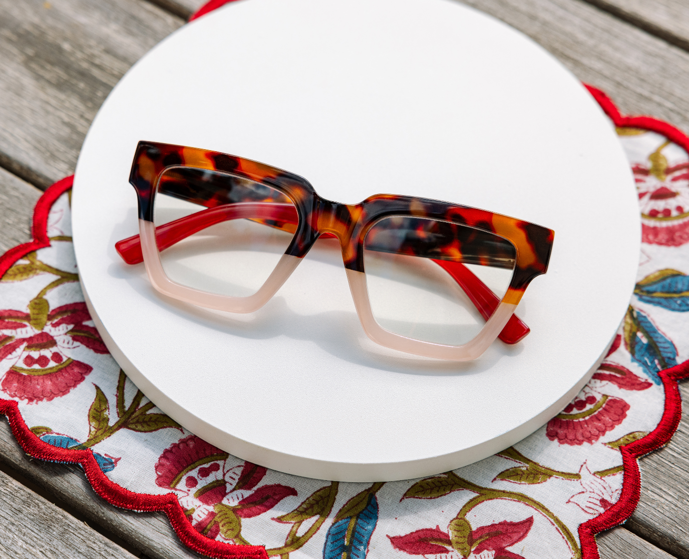 Peepers Take A Bow reading glasses in tortoise and blush, styled flat lay