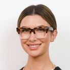 Woman wearing Peepers Take A Bow blue light reading glasses in tortoise and blush