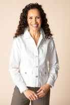 Woman wearing a white shirt against a beige background