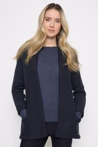 Woman wearing the Picadilly Open Front Long Jacket in Deep Navy, a relaxed sweater-knit jacket with front pockets, over a navy knit top