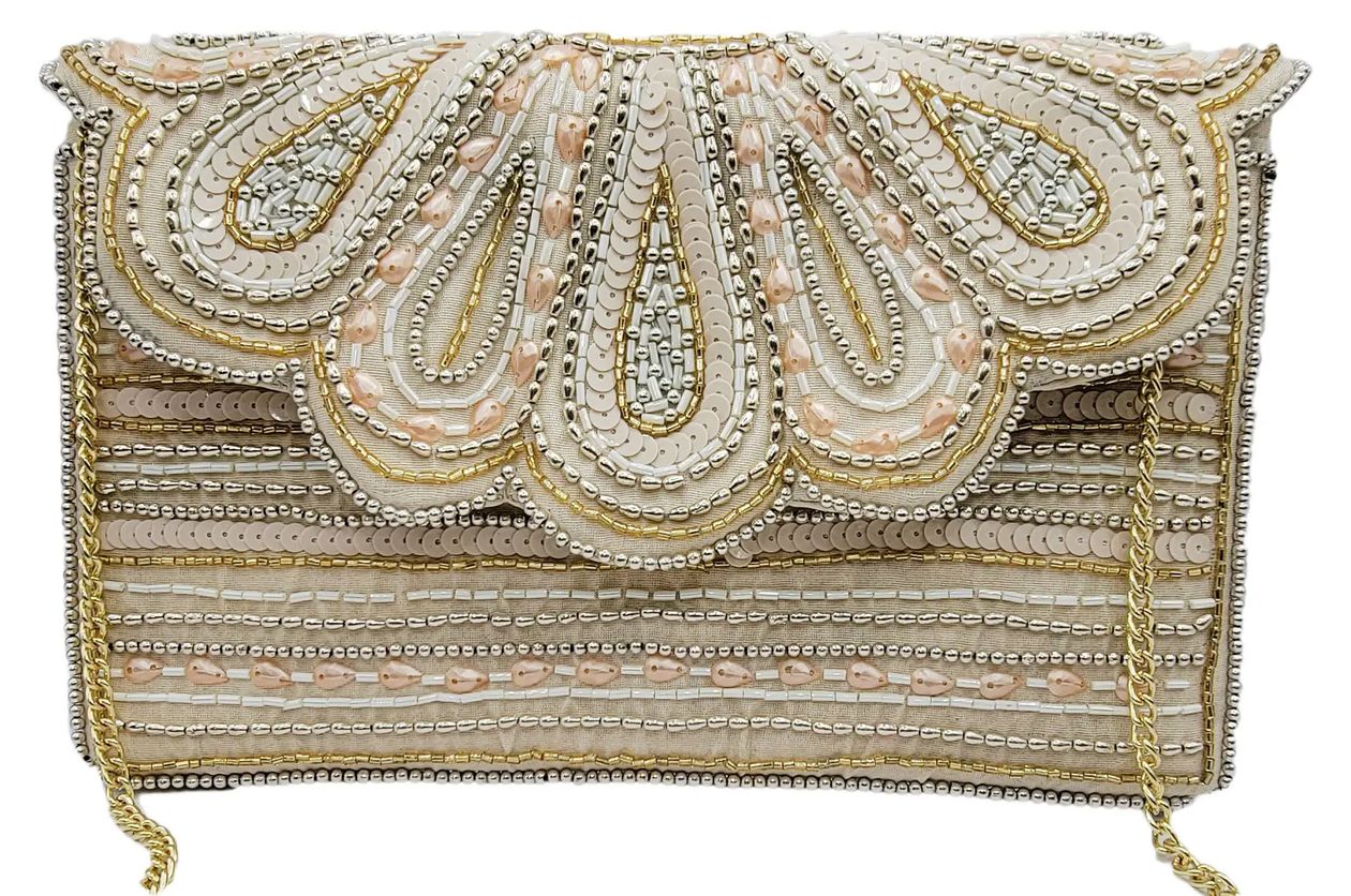 An ornate rectangular clutch bag covered in intricate beadwork and sequins, featuring a scalloped flap with teardrop motifs in cream, gold, and pale peach, with a gold chain strap visible at the sides.